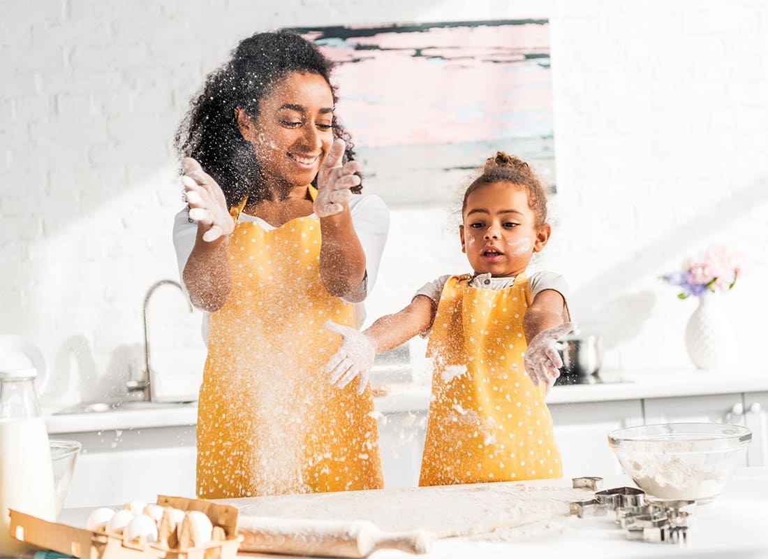 Read Our Reviews - Cheerful Mother and Daughter Having Fun Playing with Flour While Baking in the Kitchen